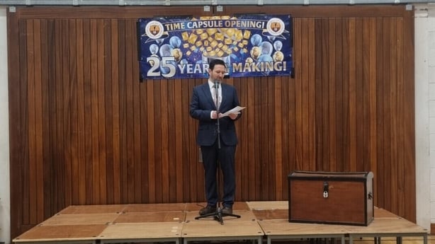 Principal Kieran Lyons stands on stage.