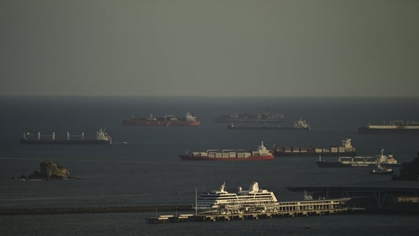 This view shows several cargo ships waiting to transit the Panama Canal on the Pacific side in Panama City