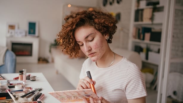 Photo of a young woman applying make-up