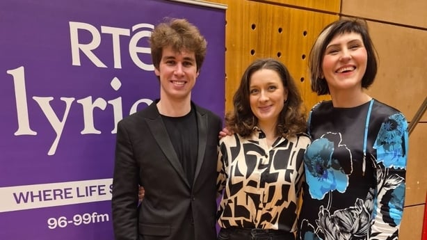 Swann Van Rechem, Silvija Ščerbavičiūtė and Liz Nolan standing together, smiling at the camera. They are standing beside an RTÉ lyric fm purple sign.