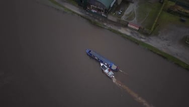 Runaway barge rescued after breaking free of moorings amid flooding