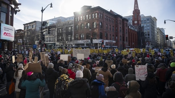 Demonstrators at a rally against President Donald Trump, ICE raids, arrests and the Trump administration in Washington, DC.