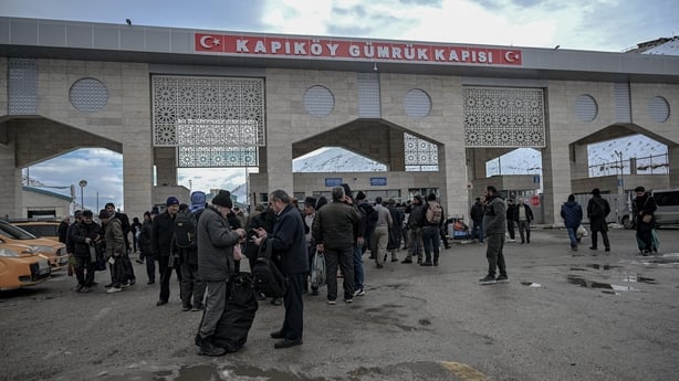 People gather in front of a building 