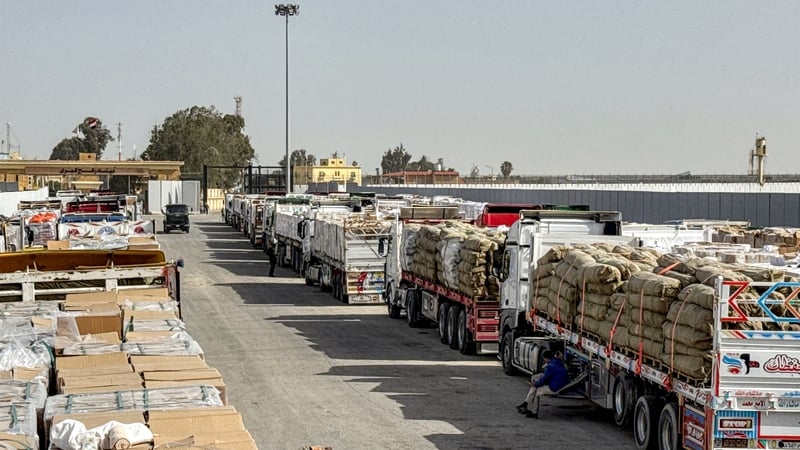 Trucks transporting humanitarian aid wait to enter through the Egyptian side of the Rafah border crossing with the Gaza Strip