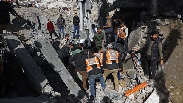 Rescuers look through rubble in Gaza