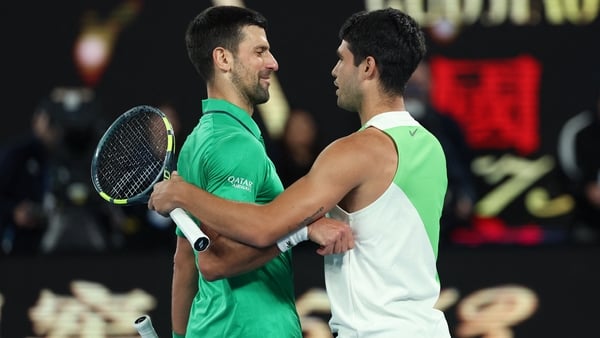 Serbia's Novak Djokovic (L) greets Spain's Carlos Alcaraz on his victory after their men's singles final match on day fifteen of the Australian Open tennis tournament in Melbourne on February 1, 2026. (Photo by Martin KEEP / AFP) / -- IMAGE RESTRICTED TO