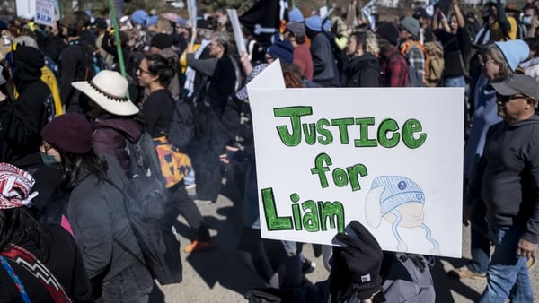 People protest against Immigration and Customs Enforcement as they march toward the South Texas Family Residential Center on January 28
