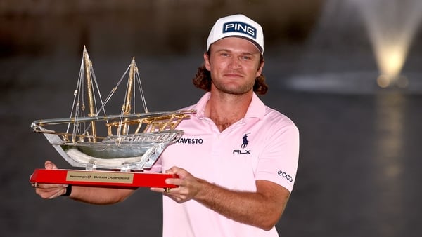 Freddy Schott of Germany poses with the trophy on the 18th green following victory on day four of the Bahrain Championship 2026 at Royal Golf Club on February 01, 2026 in Bahrain, Bahrain