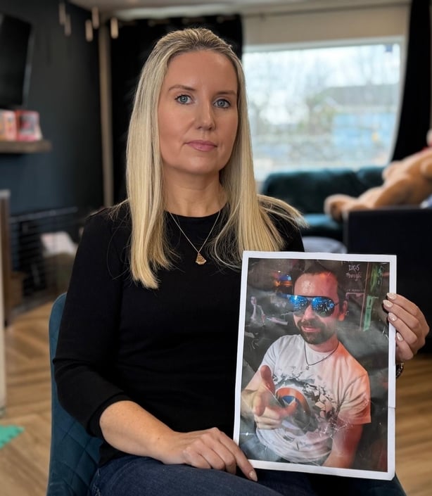 Sharon Lynn holding a photo of her brother Martin