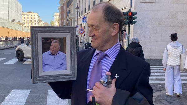David Ryan holding a picture of his late brother Mark Ryan before meeting the Pope at the Vatican