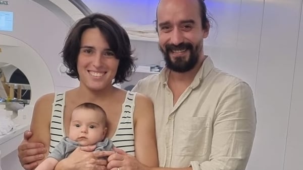 Dr Anna Truzzi is pictured holding her daughter Maeve, who took part in the study, flanked by her husband.