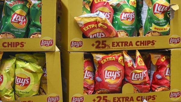Packets of Lay's crisps in boxes in a supermarket