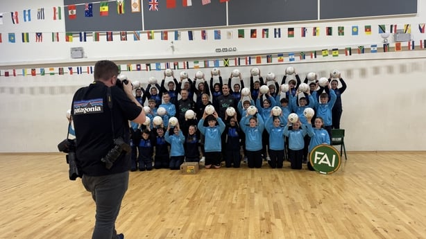 Students at Carrigtwohill Community National School being pictured with footballs presented by the FAI