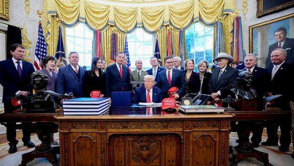 US President Donald Trump, center, joined by members of the House and Senate, during a bill signing in the Oval Office of the White House in Washington, DC, US, on Tuesday, Feb. 3, 2026. The partial US government shutdown is on track to end later Tuesday