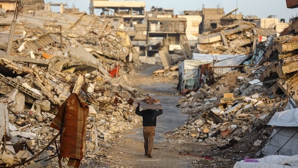 A displaced Palestinians among the rubble in the Sheikh Radwan neighborhood in Gaza City, Gaza