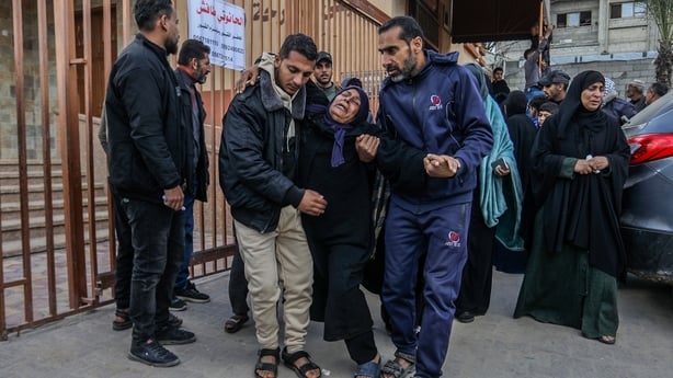 Palestinians mourn during the funeral of four people, including children, who died in Israeli artillery attacks in Khan Yunis, Gaza