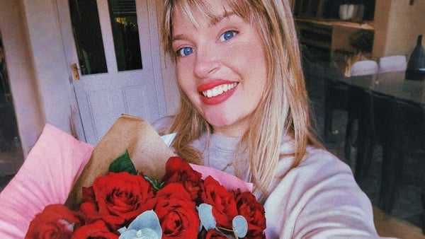 Tara Povey posing with flowers
