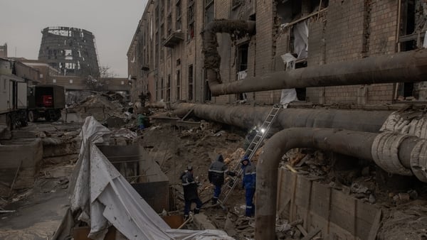 men at work at a damaged factory in kyiv