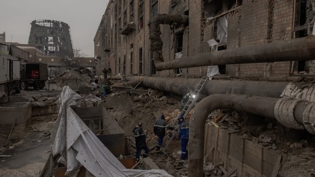 men at work at a damaged factory in kyiv