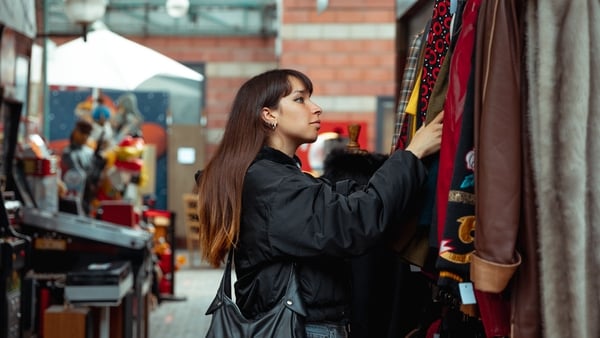 Young woman shopping vintage clothing