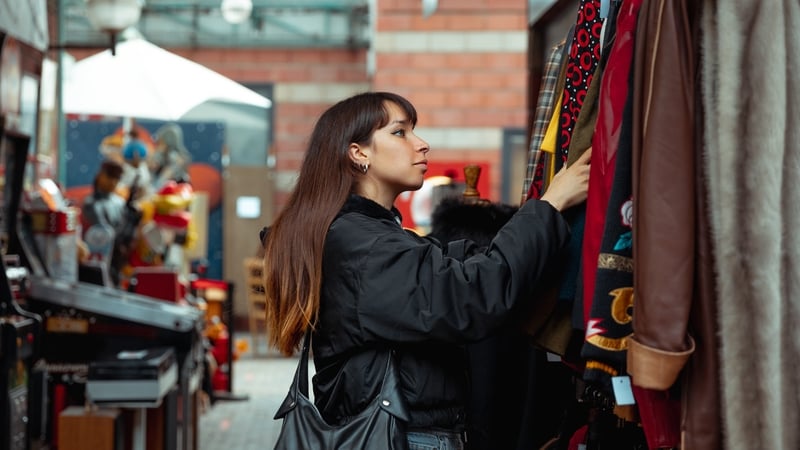 Young woman shopping vintage clothing