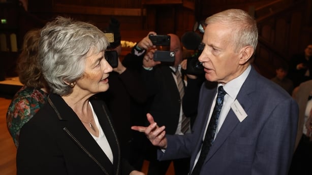 Catherine Connolly speaking to Gregory Campbell who is gesturing with his hands