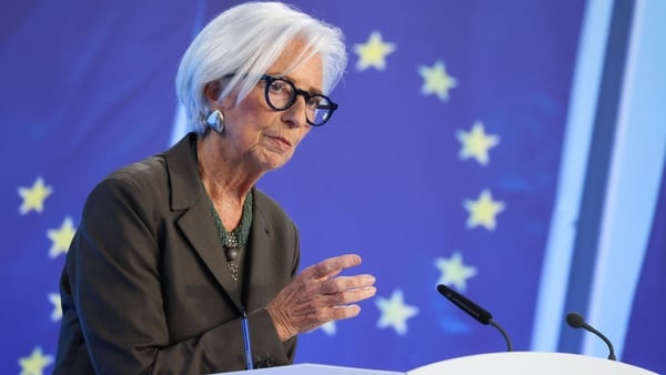 ECB President Christine Lagarde on a stage with the EU stars behind her