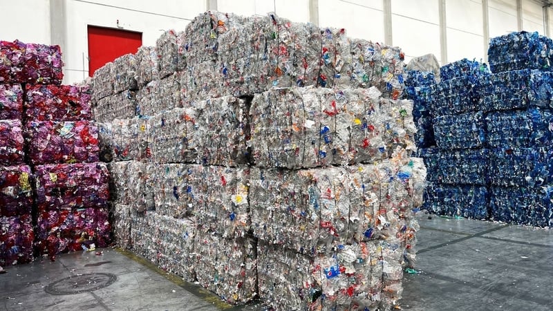Blocks of flattened plastic bottles and cans ready for recycling