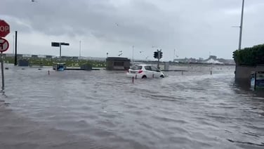 A car drives through a flooded road in Sandycove, Co Dublin
