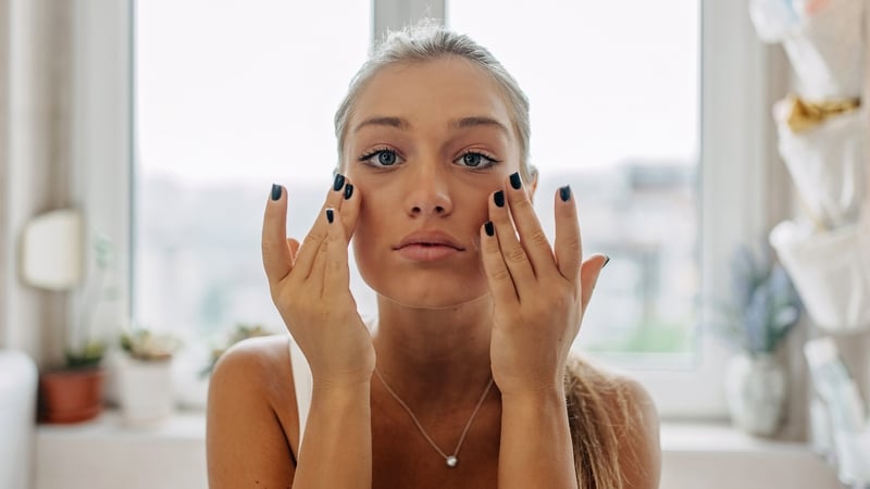 Tired woman treating skin