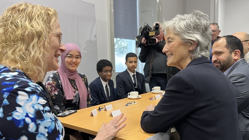 A group of people sit around a table talking
