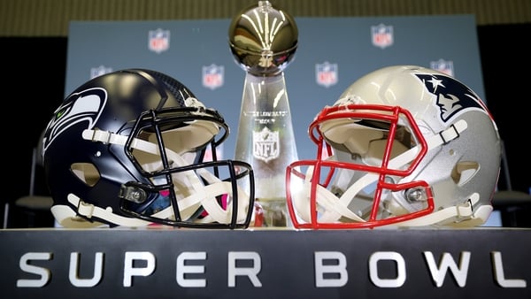 SAN JOSE, CALIFORNIA - FEBRUARY 02: The Vince Lombardi Trophy is framed by the Seattle Seahawks and New England Patriots helmets during Super Bowl LX Opening Night at San Jose McEnery Convention Center on February 02, 2026 in San Jose, California. (Photo