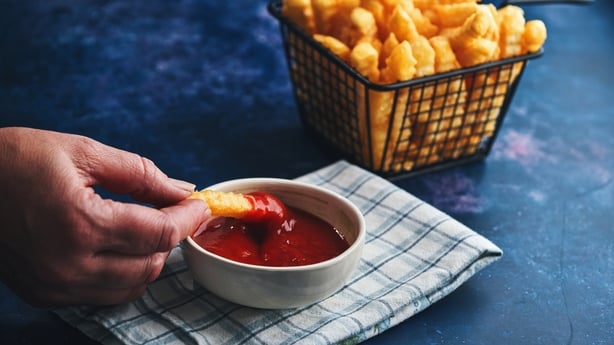 Crispy fries in a basket with ketchup for dipping