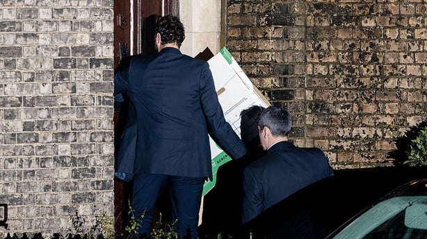 Police Officers carry empty boxes into the home of Peter Mandelson
