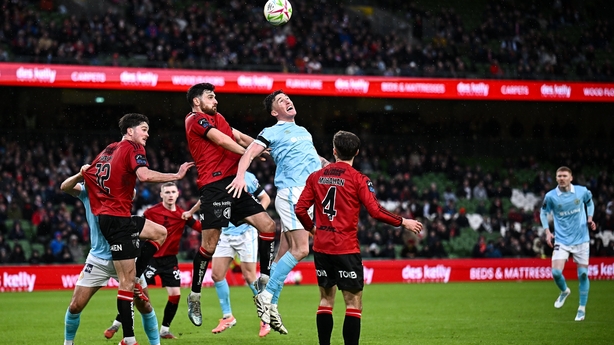 Jordan Flores of Bohemians and Joe Redmond of St Patrick's Athletic have their eyes on the ball - Premier Division, February 2026