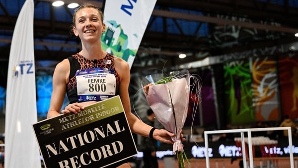 Femke Bol with a 'National Record' sign