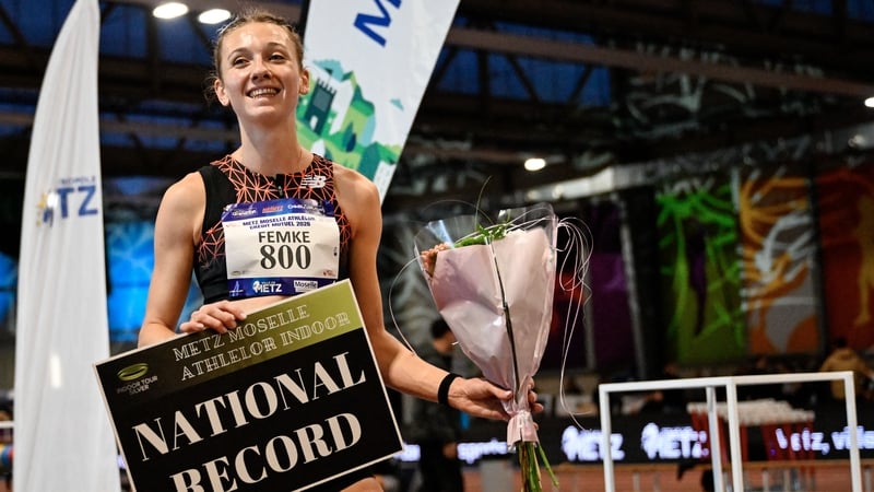 Femke Bol with a 'National Record' sign