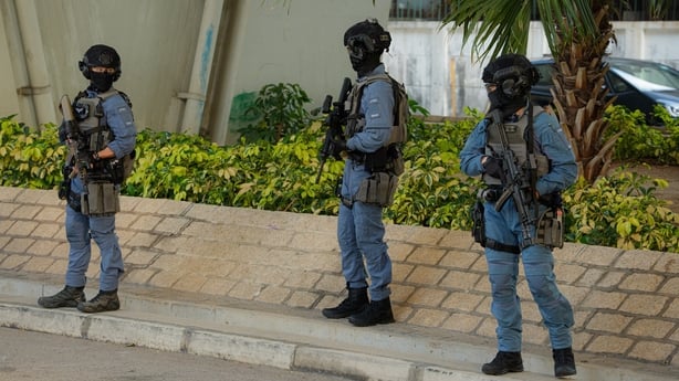 Armed police officers stand guard outside the West Kowloon Court ahead of a sentencing hearing for Jimmy Lai in Hong Kong.
