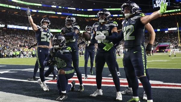 Seattle Seahawks linebacker Tyrice Knight (48), safety Julian Love (20), linebacker Patrick O'Connell (52), linebacker Drake Thomas (42), safety Nick Emmanwori (3), and additional players celebrate after an interception during the second half of the NFL S