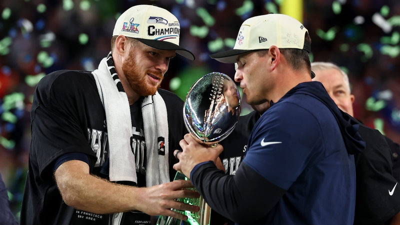 SANTA CLARA, CALIFORNIA - FEBRUARY 8: Mike MacDonald and Sam Darnold #14 of the Seattle Seahawks lift the Vince Lombardi Trophy after the NFL Super Bowl LX football game against the New England Patriots, at Levi's Stadium on February 8, 2026 in Santa Clar