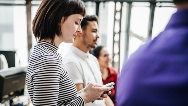woman on phone during meeting