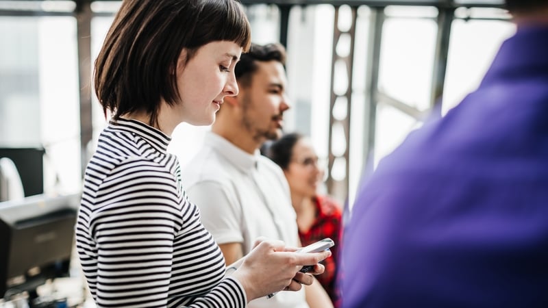 woman on phone during meeting