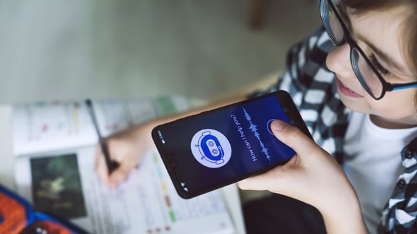 Boy using system AI Chatbot on mobile application to do his homework