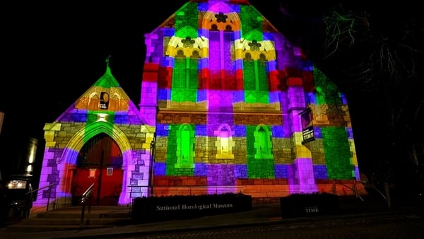 A historic building in Waterford is illuminated in an array of colours