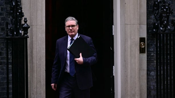 Britain's Prime Minister Keir Starmer leaves 10 Downing Street holding a folder 