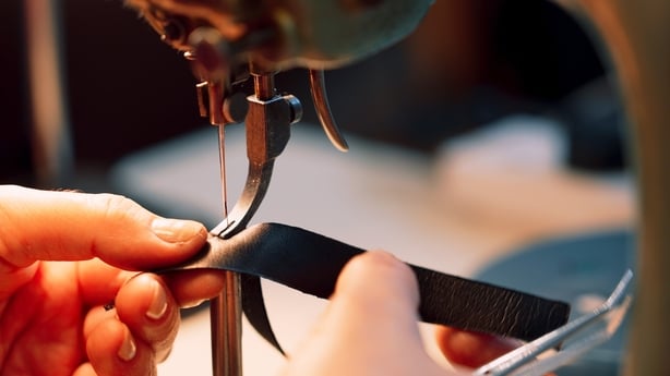 A photo of a maker working on a sewing machine
