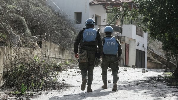Two soldiers wearing blue helmets