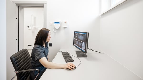 Doctor looks at the 3d scan of the jaw on the computer in office near X-ray room
