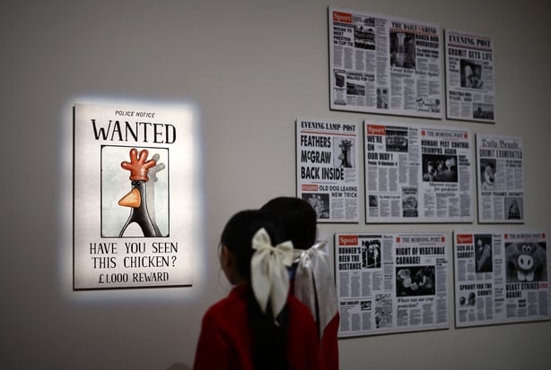 People look at a Wanted poster for the Wallace & Gromit character Feathers McGraw, during a photocall for the Inside Aardman: Wallace & Gromit and Friends exhibition at the Young V&A museum in London on 9 February, 2026