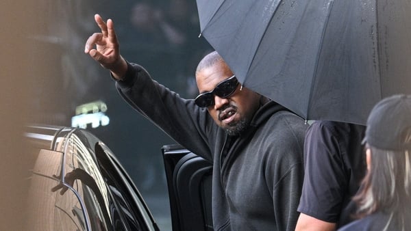 US rapper and producer Kanye West gestures upon arriving at Shanghai Pudong International Airport on 11 July, 2025